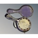 A banjo/mandolin in case.