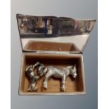A silver plated cigarette box containing three white metal animal figures