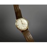 A gent's gold Omega manual wind wristwatch, silvered dial with subsidiary seconds, Omega crown,