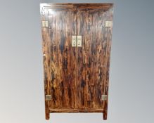 A Chinese style double door wardrobe fitted with hanging rail and shelves.