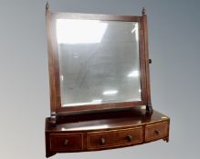A Victorian inlaid mahogany dressing table mirror fitted with three drawers.