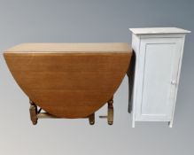 A 20th century gateleg table together with a painted pot cupboard.