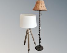 A contemporary floor lamp on tripod base together with a further floor lamp with wicker shade.