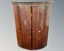A George III inlaid mahogany double door hanging corner cabinet.