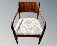 A continental carved oak framed armchair together with a mahogany armchair.