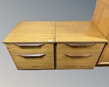 A pair of 20th century teak veneered two drawer bedside stands.