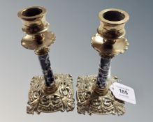 A pair of Victorian brass candlesticks with ceramic stems, height 14.5 cm.