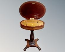 A 19th century continental mahogany sewing table on quatrefoil base.