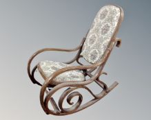 A beech framed bentwood rocking chair in tapestry upholstery.