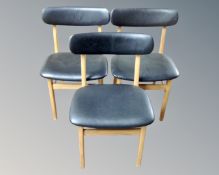 A set of three late 20th century Scandinavian dining chairs in black vinyl upholstery.