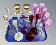 A tray of assorted gilt and coloured drinking glasses and candle sticks