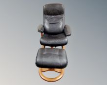 A contemporary swivel armchair and matching footstool in brown leather upholstery.