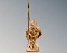 A cast iron figure of a knight with halberd,