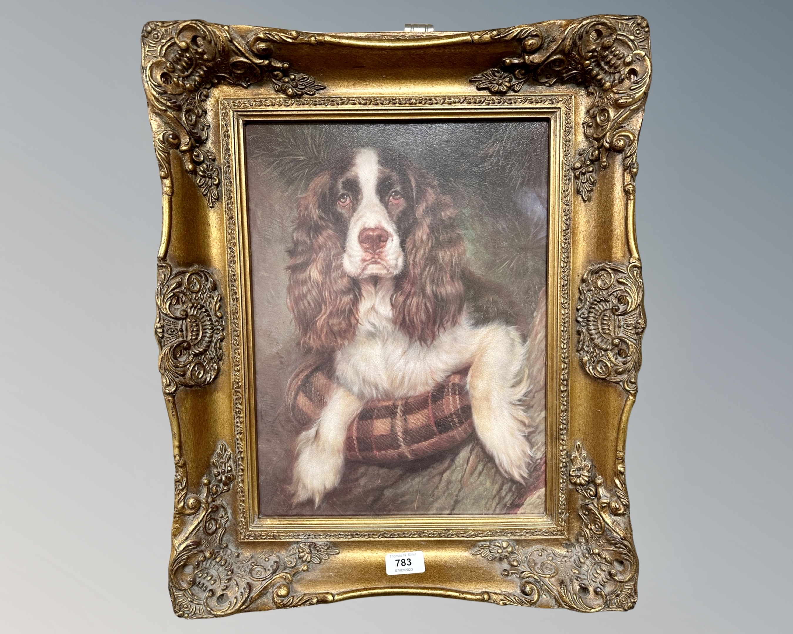 A gilt framed colour print depicting a spaniel, 29cm by 39cm.