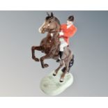 A Beswick huntsman on rearing brown horse no. 868, later version with white trousers.
