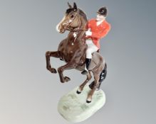 A Beswick huntsman on rearing brown horse no. 868, later version with white trousers.