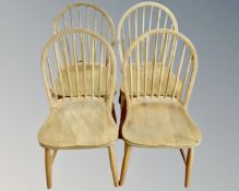 A set of four oak stickback dining chairs.