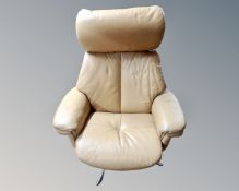 A late 20th century tan leather swivel armchair on metal base.