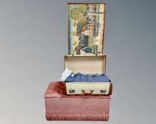 A fabric storage ottoman, a vintage luggage case and a large oil on canvas.