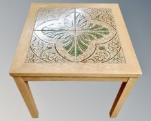 A continental square tile topped hand table.