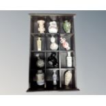A wooden display case containing twelve assorted Japanese porcelain vases