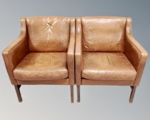 A pair of Scandinavian tan leather armchairs