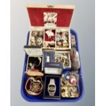 A tray containing a jewellery box and costume jewellery, assorted lady's wristwatches, badges,