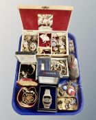A tray containing a jewellery box and costume jewellery, assorted lady's wristwatches, badges,