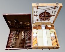 A brass and wooden handled picnic cutlery set together with a further 20th century picnic set.