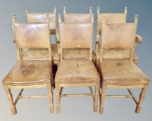 A set of six oak and studded tan leather upholstered dining chairs.