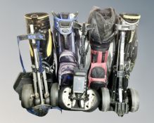 Four golf bags and three trolleys.