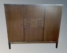 A continental walnut sideboard fitted with cupboards and drawers.
