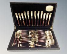 A canteen of brass and wooden handled cutlery