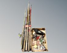 A large bundle of assorted fishing rods together with a further box containing fishing reels,