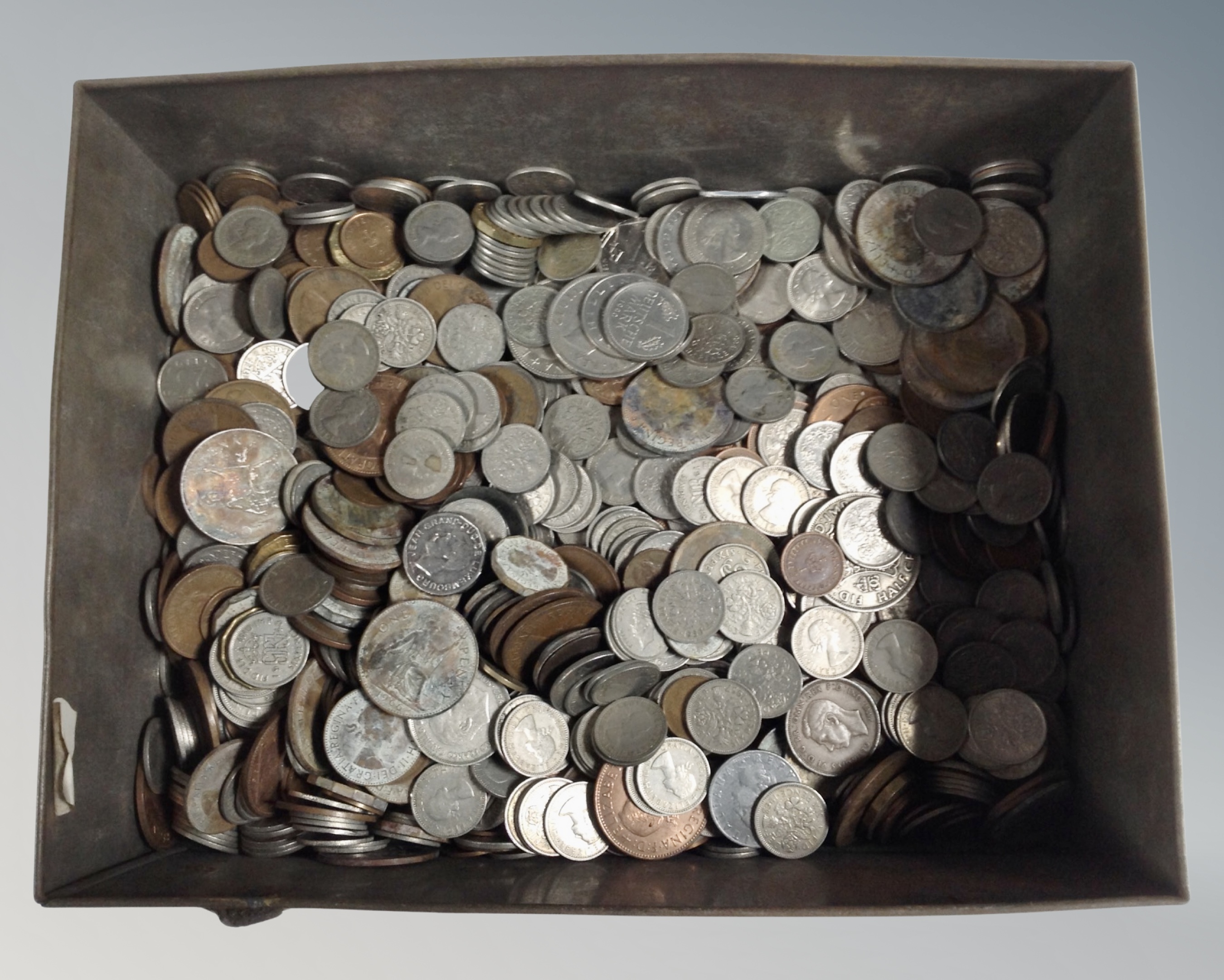 A tin of mixed coins,