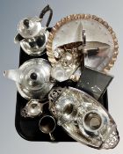 A tray of hammered pewter four piece tea set, photograph frame, tea strainer,