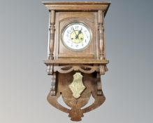 A Continental oak eight day wall clock with enamelled dial