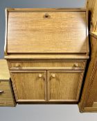 A 20th century teak veneered fall front writing bureau.