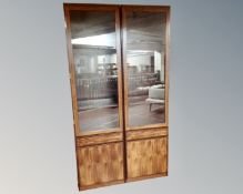 A pair of 20th century continental rosewood effect glazed cabinets.