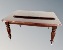 A Victorian extending dining table with leaf.