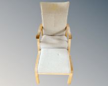 A blond oak framed relaxer chair with matching footstool.