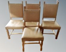 A set of three oak framed dining chairs in studded tan leather upholstery together with a similar