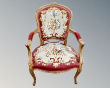 A carved beech salon armchair in tapestry upholstery.