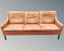 A 20th century Scandinavian tan leather three seater settee,