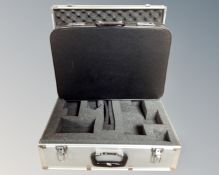 An aluminium flight case together with a briefcase