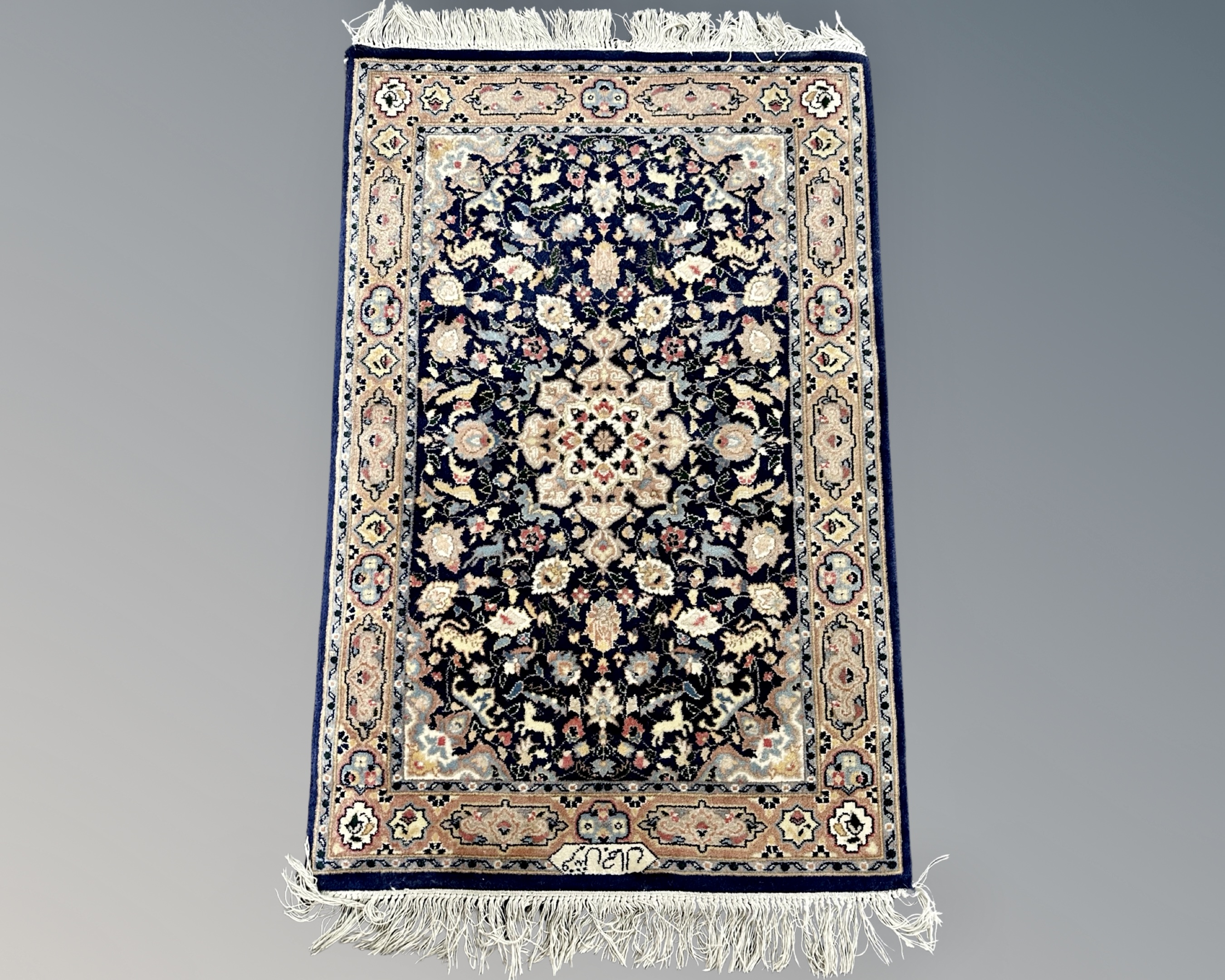 A Nain rug, Central Iran, signed, 106 cm x 62 cm.