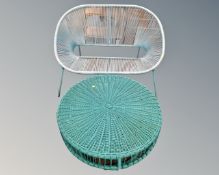 A wicker bench together with a similar circular coffee table.