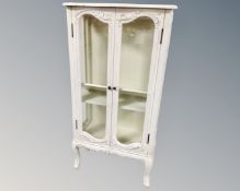 A French style double door glazed display cabinet in scumbled painted finish.