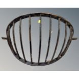 A cast iron wall mounted hay rack.