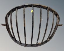A cast iron wall mounted hay rack.